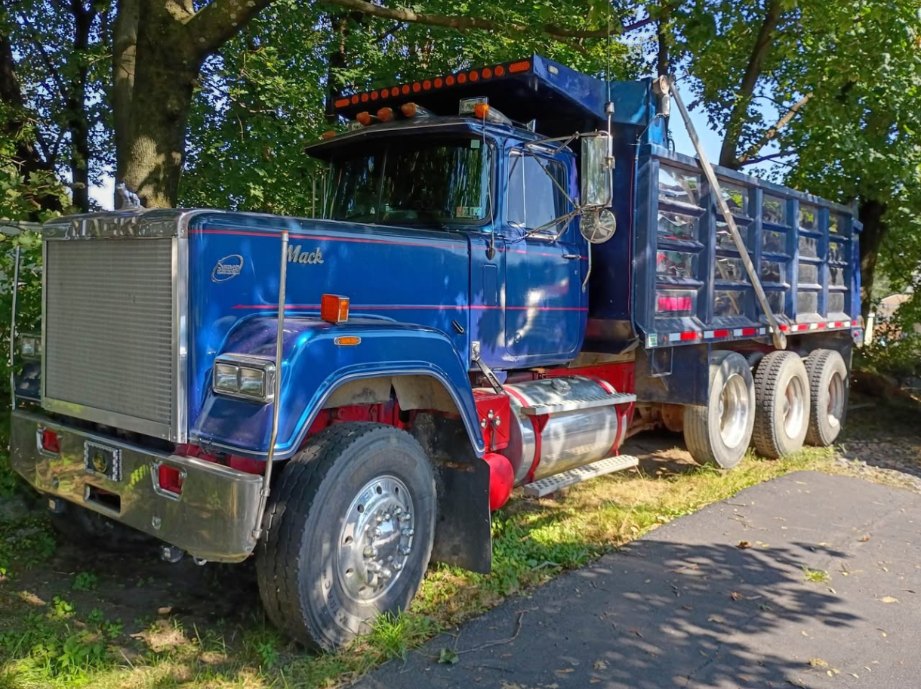 Blackstreet's blue Mack tri-axle dump truck parked on a driveway